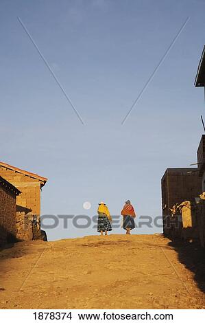 Picture - Amaryan Woman Walking Down Street On The Island Of The Sun. Fotosearch