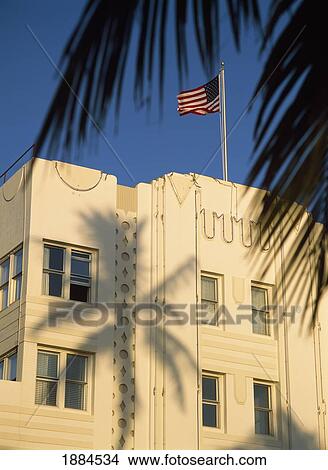 American Flag On Top Of Art Deco Building With Palm Tree Shadow View Large Photo Image Picture - American Flag On Top Of Art Deco Building With Palm Tree Shadow. Fotosearch