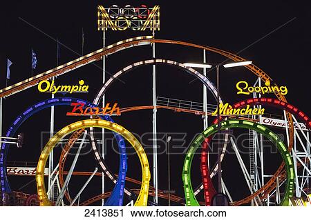 Stock Image - Amusement park rides illuminated at nighttime; Munich, Germany. Fotosearch