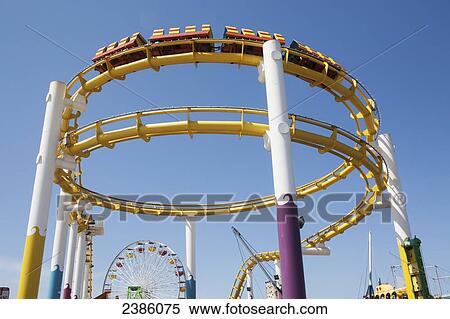 Amusement park roller coaster against a blue sky; California, United States of America View Large Photo Image Stock Photography - Amusement park roller coaster against a blue sky; California, United States of America. Fotosearch