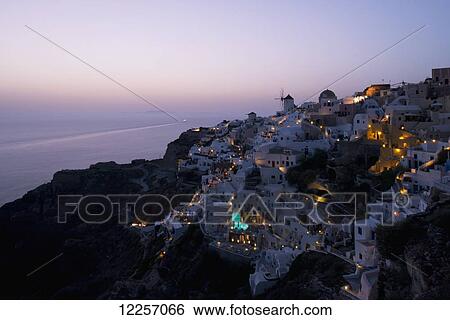 An aerial view of Oia and the windmill at dusk; Oia, Santorini, The Cyclades, The Aegean, The Greek Islands, Greece View Large Photo Image Stock Photograph - An aerial view of Oia and the windmill at dusk; Oia, Santorini, The Cyclades, The Aegean, The Greek Islands, Greece. Fotosearch