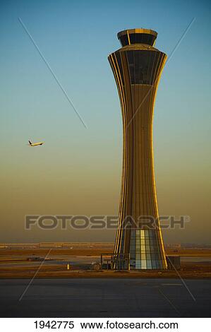 An Airplane Flies Past The Air Traffic Control Tower At The Beijing Airport; Beijing China View Large Photo Image Stock Photography - An Airplane Flies Past The Air Traffic Control Tower At The Beijing Airport; Beijing China. Fotosearch