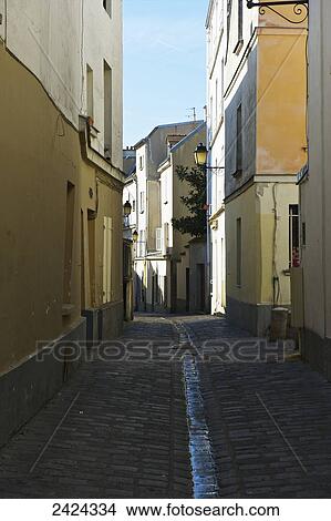 An alley with water flowing in a gutter between buildings; Paris, France View Large Photo Image Picture - An alley with water flowing in a gutter between buildings; Paris, France. Fotosearch