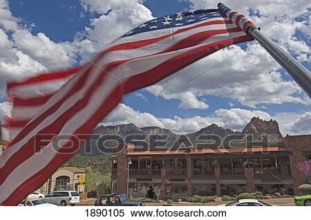 An American Flag Flying In The Wind In Downtown Sedona. View Large Photo Image Stock Photography - An American Flag Flying In The Wind In Downtown Sedona.. Fotosearch