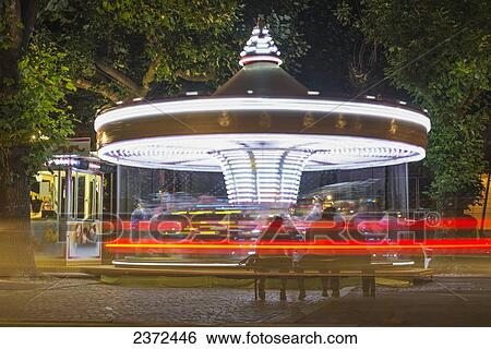 Stock Photograph - An Amusement Park Ride Illuminated At Nighttime; Locarno, Ticino, Switzerland. Fotosearch