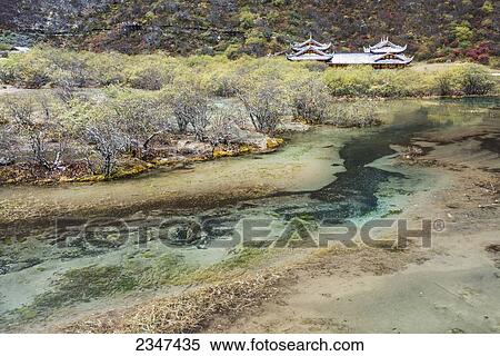 Stock Photography - An Ancient Tibetan Buddhist Temple In A Green Valley With Colorful Ponds And Brooks; Huanglong, Sichuan Province, China. Fotosearch