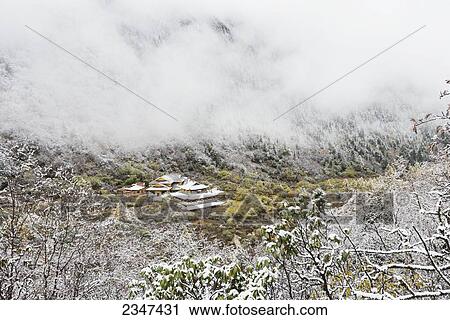 An Ancient Tibetan Buddhist Temple Between Two Snowy Mountain Slopes In The Mist; Huanglong, Sichuan Province, China View Large Photo Image Stock Image - An Ancient Tibetan Buddhist Temple Between Two Snowy Mountain Slopes In The Mist; Huanglong, Sichuan Province, China. Fotosearch