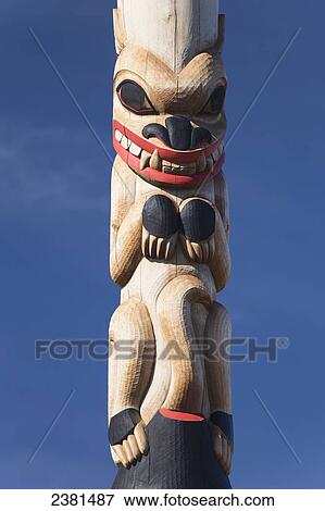 An animal carved and painted on a wooden totem pole against a blue sky; Whitehorse, Yukon, Canada View Large Photo Image Stock Photo - An animal carved and painted on a wooden totem pole against a blue sky; Whitehorse, Yukon, Canada. Fotosearch