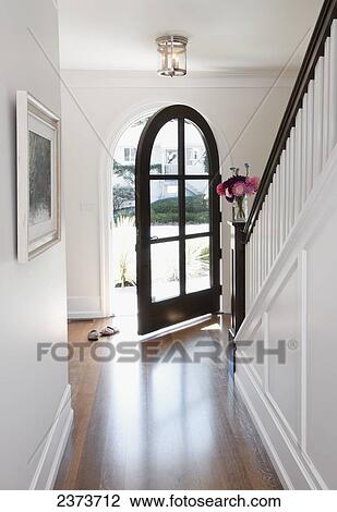 Stock Image - An Arched Doorway Opens To A Contemporary Ocean-Side Home; Vancouver Island, British Columbia, Canada. Fotosearch