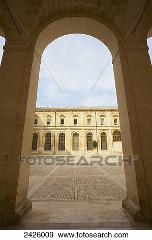 Stock Photo - An arched walkway in the old quarter of Lecce; Salento, Italy. Fotosearch