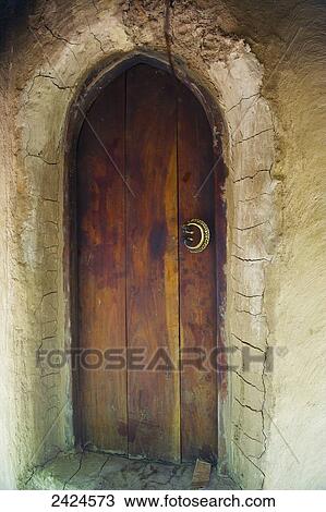 An arched wooden door with cracked wall around it; Ulpotha, Embogama, Sri Lanka View Large Photo Image Stock Image - An arched wooden door with cracked wall around it; Ulpotha, Embogama, Sri Lanka. Fotosearch