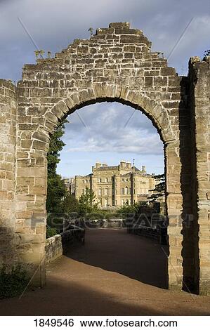 Stock Photograph - An Archway Leading To A Large Stone Building; Scotland. Fotosearch