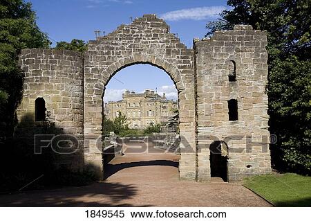 Stock Photography - An Archway Leading To A Large Stone Building. Fotosearch