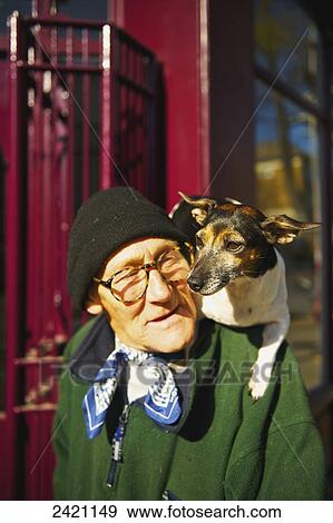 An elderly man walks with his pet dog sitting on his shoulders, Portobello Road Market; London, England View Large Photo Image Stock Photo - An elderly man walks with his pet dog sitting on his shoulders, Portobello Road Market; London, England. Fotosearch