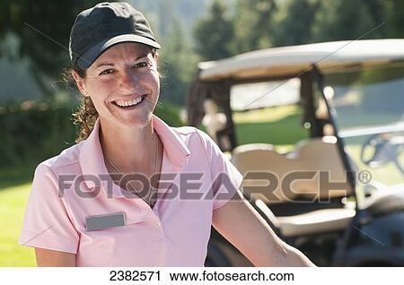 Stock Image - An enthusiastic female member of the guest services team at the Whistler Golf Course; Whistler, British Columbia, Canada. Fotosearch