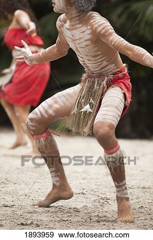 Stock Photo - An Indigenous Man And A Woman Dancing On The Sand; Queensland, Australia. Fotosearch