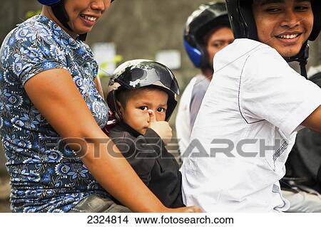 An Indonesian Family On Motorbike, Bali, Indonesia View Large Photo Image Picture - An Indonesian Family On Motorbike, Bali, Indonesia. Fotosearch