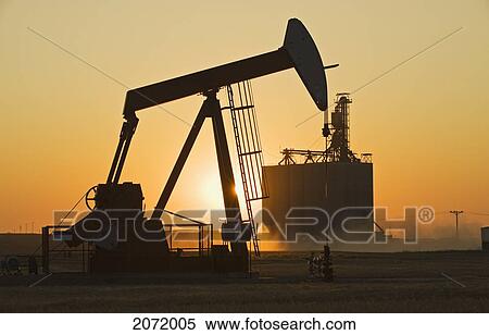 An Oil Pumpjack In A Wheat Field With An Inland Grain Terminal In The Background, Gull Lake, Saskatchewan View Large Photo Image Stock Photography - An Oil Pumpjack In A Wheat Field With An Inland Grain Terminal In The Background, Gull Lake, Saskatchewan. Fotosearch