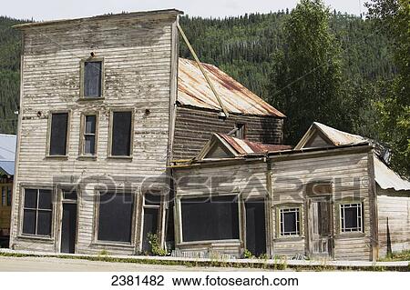 Stock Image - An old abandoned wooden building falling down; Dawson City, Yukon, Canada. Fotosearch