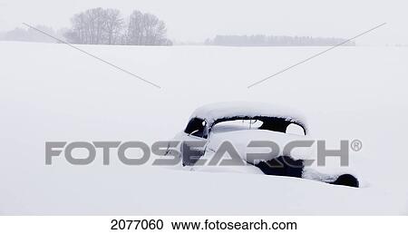 An Old Car Buried In Snow In A Field; Parkland County Alberta Canada View Large Photo Image Stock Image - An Old Car Buried In Snow In A Field; Parkland County Alberta Canada. Fotosearch
