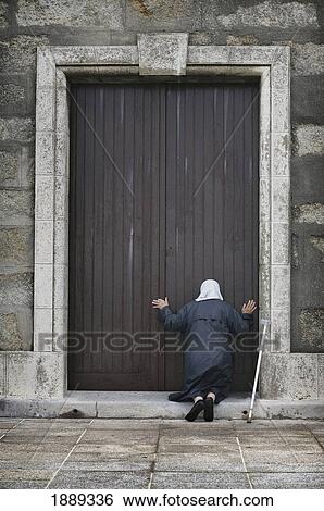 An Old Lady Kneels In Worship At The Door Of The Church View Large Photo Image Stock Photograph - An Old Lady Kneels In Worship At The Door Of The Church. Fotosearch