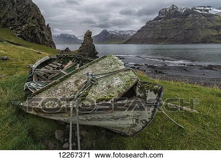 An old skiff lies rotting along the Strandir Coast in the West Fjords area of Northwestern Iceland; Iceland View Large Photo Image Stock Image - An old skiff lies rotting along the Strandir Coast in the West Fjords area of Northwestern Iceland; Iceland. Fotosearch