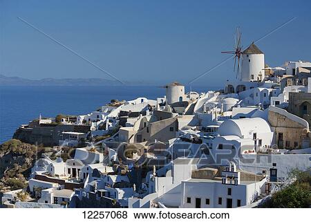 Stock Photo - An old windmill above traditional painted houses; Oia, Santorini, Cyclades, Greek Islands, Greece. Fotosearch