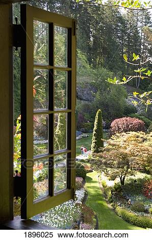 Stock Photography - An Open Window Overlooking A Lush Garden; Victoria, British Columbia, Canada. Fotosearch