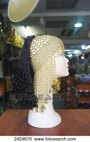 An ornate hat and hair extensions displayed on a mannequin head in a shop; London, England View Large Photo Image Stock Image - An ornate hat and hair extensions displayed on a mannequin head in a shop; London, England. Fotosearch