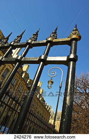 An ornate metal railing by a building and blue sky, Marais district; Paris, France View Large Photo Image Stock Photograph - An ornate metal railing by a building and blue sky, Marais district; Paris, France. Fotosearch