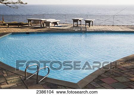 An outdoor swimming pool with a view of the ocean; California, United States of America View Large Photo Image Picture - An outdoor swimming pool with a view of the ocean; California, United States of America. Fotosearch