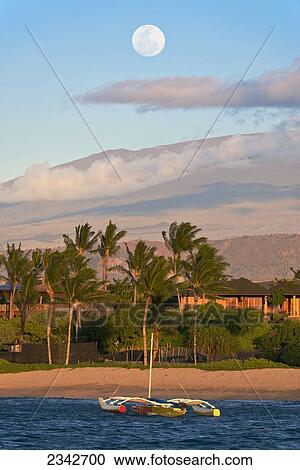 An outrigger canoe in Kukio Bay with a view of Mauna Kea in the distance; Big Island, Hawaii, United States of America View Large Photo Image Stock Image - An outrigger canoe in Kukio Bay with a view of Mauna Kea in the distance; Big Island, Hawaii, United States of America. Fotosearch