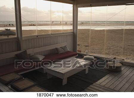 Stock Photo - An Room Enclosed By Windows Just Off The Beach. Fotosearch