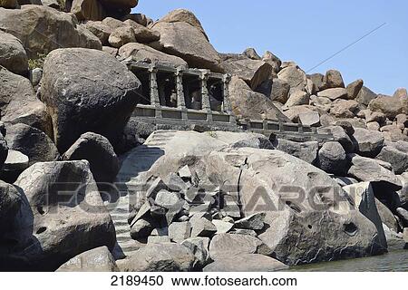 Stock Image - Ancient Shiva Temple Along The Tungabhadra River In Hampi, Karnataka, India. Fotosearch