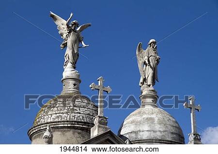 Picture - Angel statue atop a mausoleum at the Cementerio de la Recoleta, Buenos Aires, Capital Federal, Argentina. Fotosearch