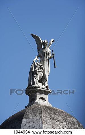 Picture - Angel statue atop a mausoleum at the Cementerio de la Recoleta, Buenos Aires, Capital Federal, Argentina. Fotosearch