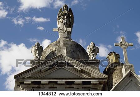 Stock Image - Angel statue atop a mausoleum at the Cementerio de la Recoleta, Buenos Aires, Capital Federal, Argentina. Fotosearch