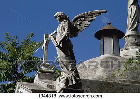 Stock Photo - Angel statue atop a mausoleum at the Cementerio de la Recoleta, Buenos Aires, Capital Federal, Argentina. Fotosearch