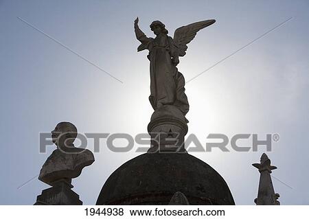 Stock Photo - Angel statue atop a mausoleum at the Cementerio de la Recoleta, Buenos Aires, Capital Federal, Argentina. Fotosearch