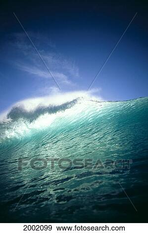 Angle View Of Green Wave With Sunlight Shining Through Top Of Wave, Blue Sky Background View Large Photo Image Stock Photo - Angle View Of Green Wave With Sunlight Shining Through Top Of Wave, Blue Sky Background. Fotosearch