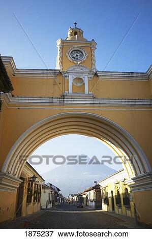 Antigua, Guatemala; A Clock In An Archway Over The Street View Large Photo Image Stock Photo - Antigua, Guatemala; A Clock In An Archway Over The Street. Fotosearch