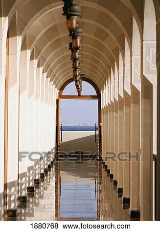 Stock Photo - Arched Hallway With Door Looking Onto Sea. Fotosearch