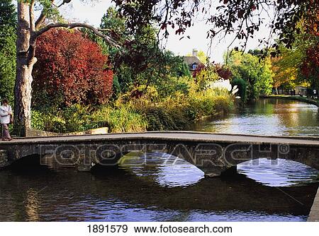 Stock Photo - Arched Stone Foot Bridge Accros River. Fotosearch