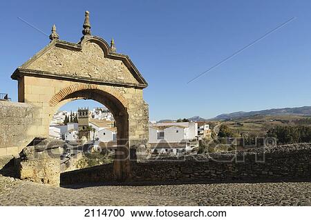 Stock Image - Archway Of Philip V Leading Over The Puente Viejo An Old Bridge Constructed In 1742; Ronda Malaga Spain. Fotosearch