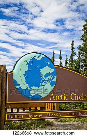 Stock Photo - Arctic Circle sign at latitude 66 33 on the Dalton Hwy, Arctic Alaska, Summer. Fotosearch
