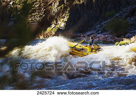 Picture - Arizona, Grand Canyon National Park, Man rafting on the Colorado River, Large rapids. EDITORIAL USE ONLY.. Fotosearch