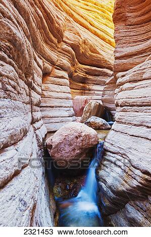 Stock Image - Arizona, Grand Canyon National Park, Matkatamiba Slot Canyon, Flowing Stream Among Amazing Rock Formations.. Fotosearch