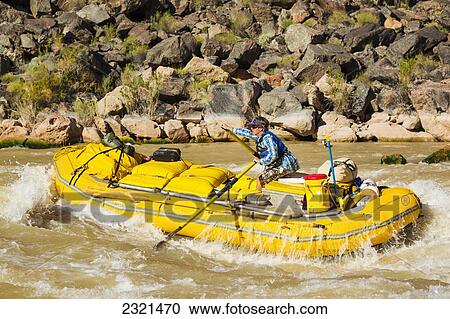 Stock Image - Arizona, Grand Canyon National Park, Man Rafting On The Colorado River. Editorial Use Only.. Fotosearch