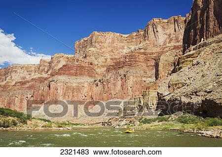 Stock Image - Arizona, Grand Canyon National Park, Young Man Rafting On The Colorado River, Calm Water. Editorial Use Only.. Fotosearch