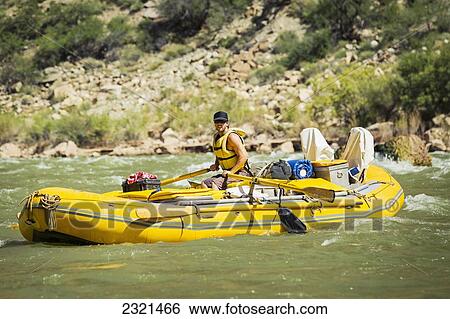 Stock Photograph - Arizona, Grand Canyon National Park, Male Rafting On The Colorado River. Editorial Use Only.. Fotosearch